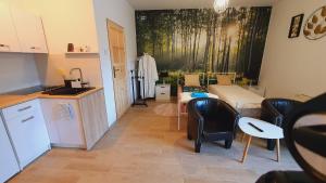 a kitchen and dining room with a table and chairs at Apartament 1 przy Termach Cieplickich in Jelenia Góra