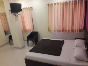 Postel nebo postele na pokoji v ubytování HOTEL SAI MEERA PALACE