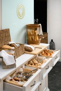 a bakery counter with baskets and pastries on it at Monastery Boutique Hotel Budapest in Budapest