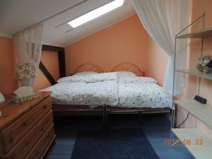 a bedroom with a bed and a dresser at Reiterhof Aumühle in Oberaula