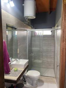 a bathroom with a shower and a toilet and a sink at Hermosa Casa en San Bernardino in San Bernardino