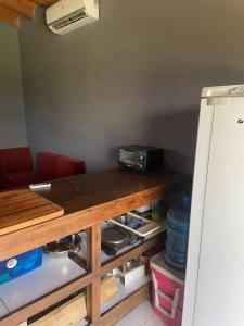 a kitchen with a table with a counter top and a refrigerator at Hermosa Casa en San Bernardino in San Bernardino