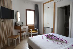 a hotel room with a bed with flowers on it at Eden Hotel in Bodrum City