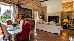 a living room with a table and a couch and a fireplace at La Templière in Villars-et-Villenotte