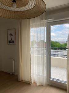 a room with a window with a view of a balcony at CAZAM Paris Saint Ouen in Saint-Ouen