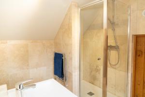 a bathroom with a shower and a sink at Mattie's Loft in Bletchingley