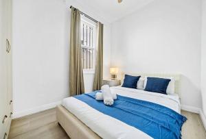 a bedroom with a large bed with blue pillows at Modern 4B2B house@Glebe in Sydney