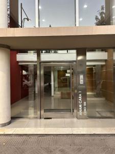 an entrance to a building with a revolving door at 4hermanos in Rufino