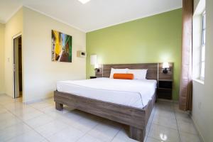 a bedroom with a large bed in a room at DeLynne Resort Curaçao in Willemstad