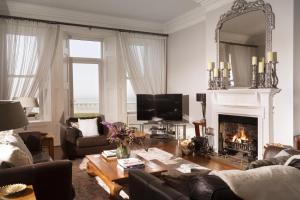 a living room with a couch and a fireplace at Harbour Heights by Bloom Stays in Folkestone