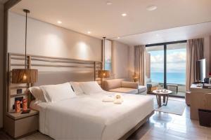 A bed or beds in a room at Angsana Corfu Resort & Spa