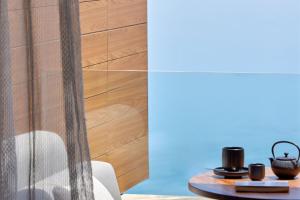 a dining room with a table and a wooden wall at Angsana Corfu Resort & Spa in Benitses
