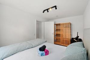 a bedroom with a bed with a stuffed animal on it at Cityapartments im ältesten Haus von Ravensburg in Ravensburg