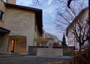 a building with a mural on the side of it at Apartments zum Bühlhof (Alfred) in Zurich