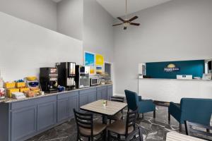 a dining room with a table and chairs and a counter at Days Inn by Wyndham Carlisle in Carlisle