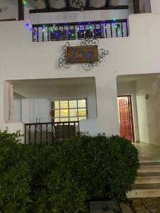 a house with a sign that reads with a stairway at Delta Sharm Apartment 156 flat 102 in Sharm El Sheikh