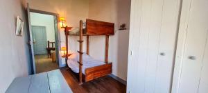 a bedroom with a bunk bed and a mirror at Maison de pays avec étage in La Couarde-sur-Mer