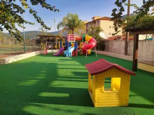 a play area with a playground with a slide at Rio Marina Resort in Mangaratiba