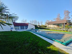 a swimming pool in the yard of a house at VILLA LUCE D'ALBA in Isola Albarella