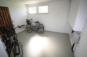 two bikes are parked in a garage at Moderne Ferienwohnung an der Ostsee im Haus Leuchtfeuer in Diedrichshagen