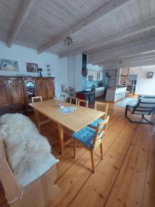 a living room with a wooden table and a couch at Villa Marlena in Spytkowice