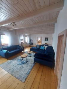 a living room with two blue couches and a table at Villa Marlena in Spytkowice