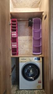 a washer and dryer in a tiny house at Servants' Quarters Studio Apartment in Valletta
