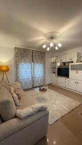 a living room with a couch and a kitchen at Apartamento Saudade in Cambados +12 photos