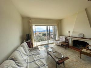 a living room with a bed and a fireplace at Villa Les Oliviers proche centre Porto-Vecchio in Porto-Vecchio