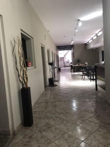 a hallway with a room with tables and chairs at Urban Jungle Hostel in San Miguel de Tucumán