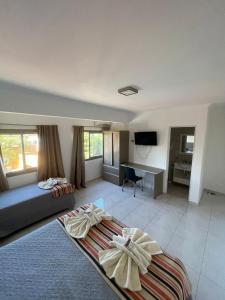 a bedroom with a bed and a desk in a room at Gran Tuyu in San Clemente del Tuyú