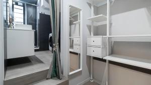 a bathroom with white cabinets and a mirror at Italianway - Jommelli 44 in Milan