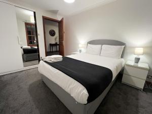 a bedroom with a large bed with a black and white comforter at 2BR Flat Historic Centre Sleeps 5 in Edinburgh