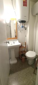 a bathroom with a toilet and a sink and a mirror at Chambre charmante chez habitant in Valencia