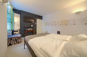 a bedroom with a bed and a tv on the wall at BASTINICA KRK Studio Ap 2, OldTown, CityCenter in Krk