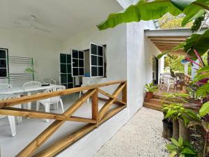 a room with a balcony with a table and chairs at Nasreenuvilla in Fuvahmulah