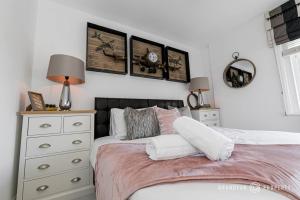 a bedroom with a bed with a dresser and a mirror at Glamorous 2-bedroom, Central location, Scenic Views - Central Park Suite in Parkstone