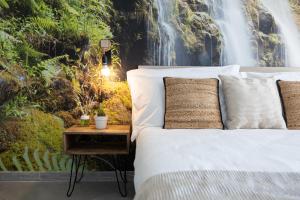 a bedroom with a bed and a waterfall mural at 6 MINUTI AIRPORT ORIO AL SERIO, VISTA FIUME E Wifi in Seriate