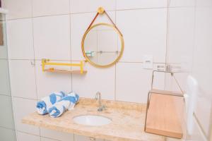 a bathroom with a sink and a mirror at Pousada Estrela da Luz Beach in Ceará-Mirim