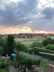 a view of a garden with a sunset in the background at Ferienhaus Raschke in Norderney