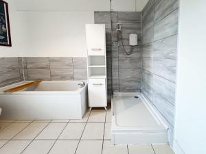 a white bathroom with a tub and a shower at Garnethill Charm 3 Bed Flat Central Glasgow in Glasgow