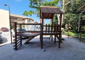 a playground with a bench and a gazebo at Apartamento em Carneiros à beira- mar - Ao lado da igrejinha dos carneiros e do bora-bora in Tamandaré +28 photos