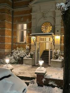 a building with two lights in the snow at Hotel Mozart Bonn in Bonn