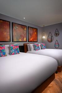 A bed or beds in a room at NYX Hotel Dublin Portobello