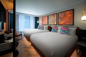 A bed or beds in a room at NYX Hotel Dublin Portobello