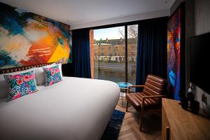 A bed or beds in a room at NYX Hotel Dublin Portobello