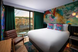 A bed or beds in a room at NYX Hotel Dublin Portobello