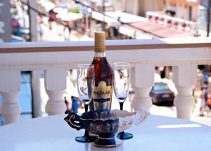 a bottle of wine and two glasses on a table at Oscar in Paralia Katerinis