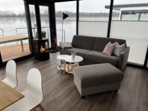 a living room with a couch and a table at Hausboot Bakerman in Zehdenick
