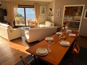 cocina y sala de estar con una mesa de madera con gafas. en Pellegrini Boutique Villa Lake View, en Verbania